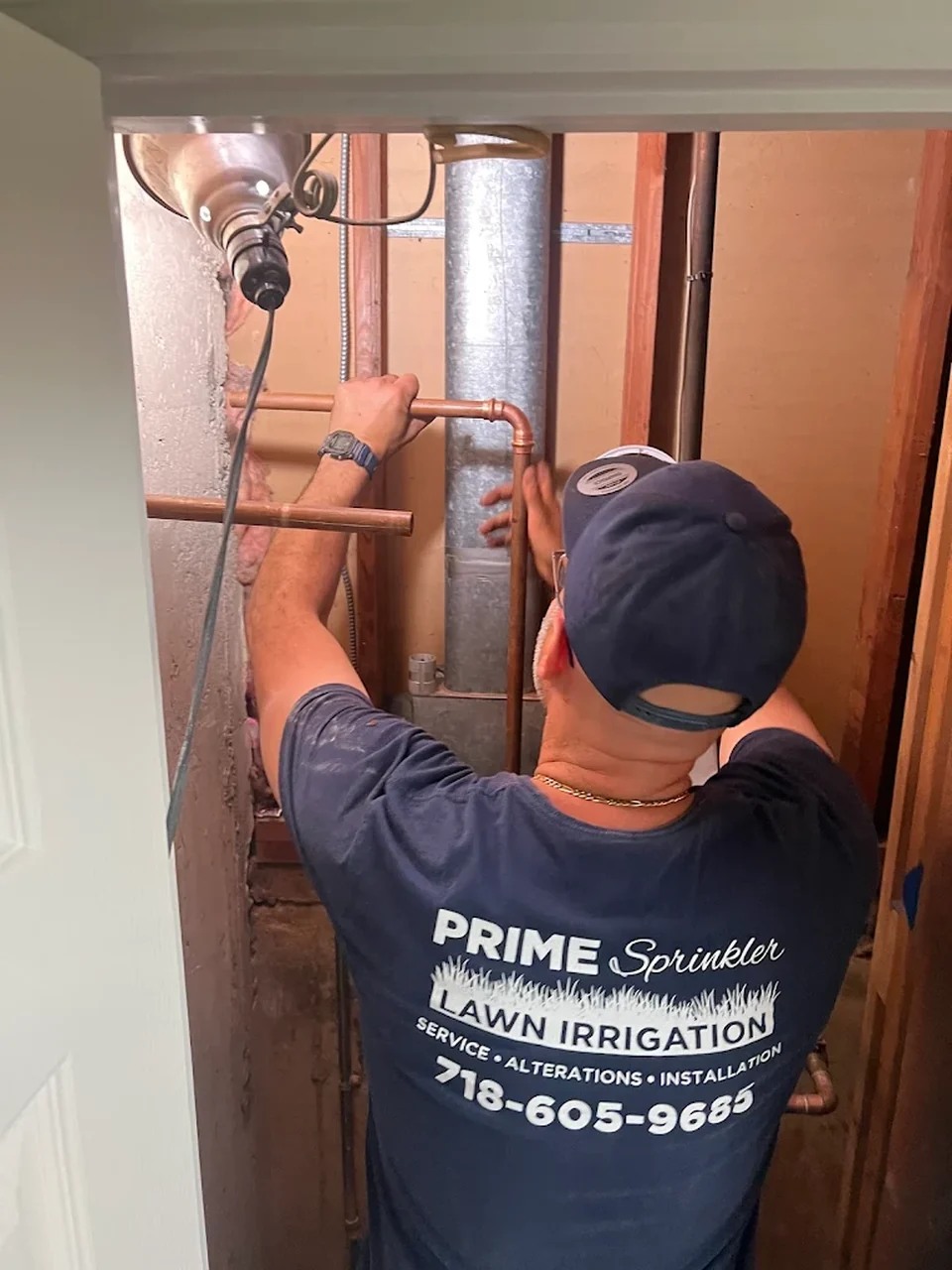 Prime Sprinkler technician working on irrigation piping