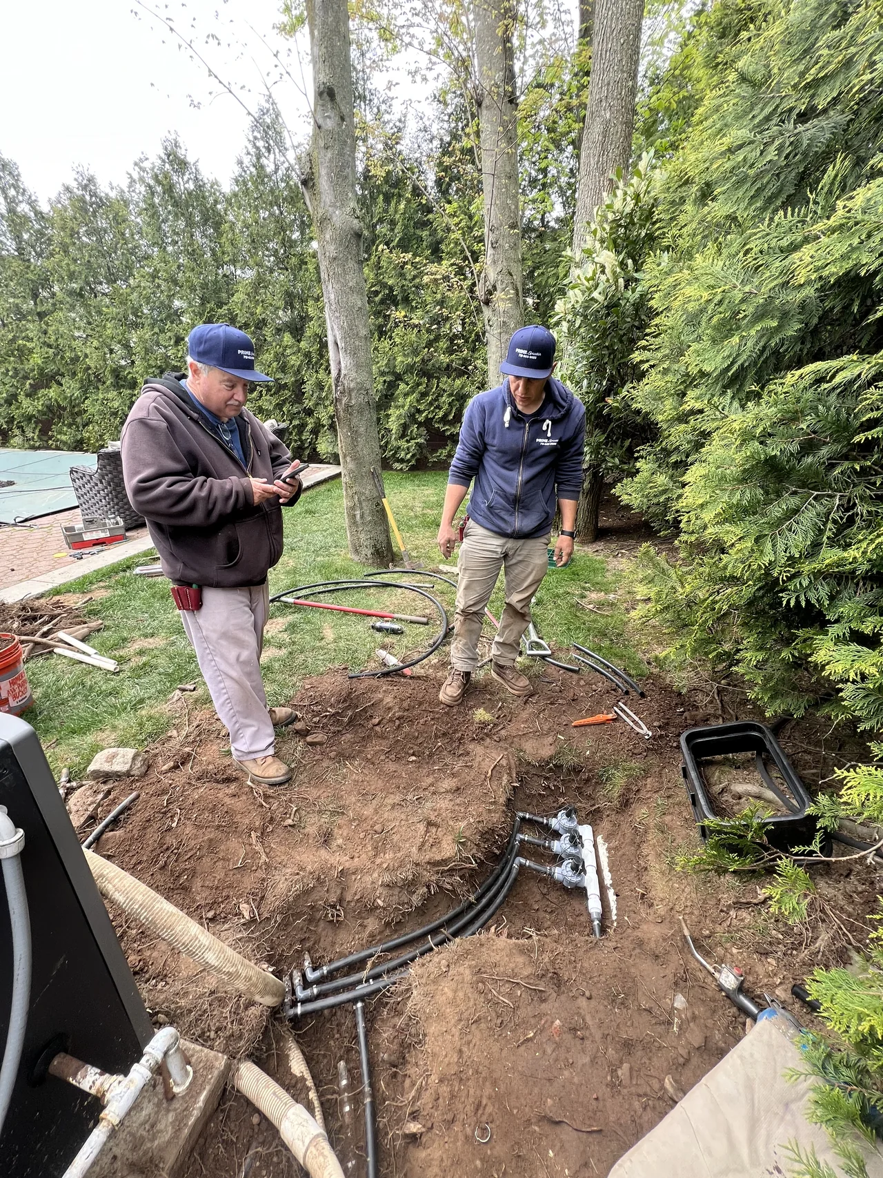 Prime Sprinkler crew working on a Staten Island lawn irrigation installation