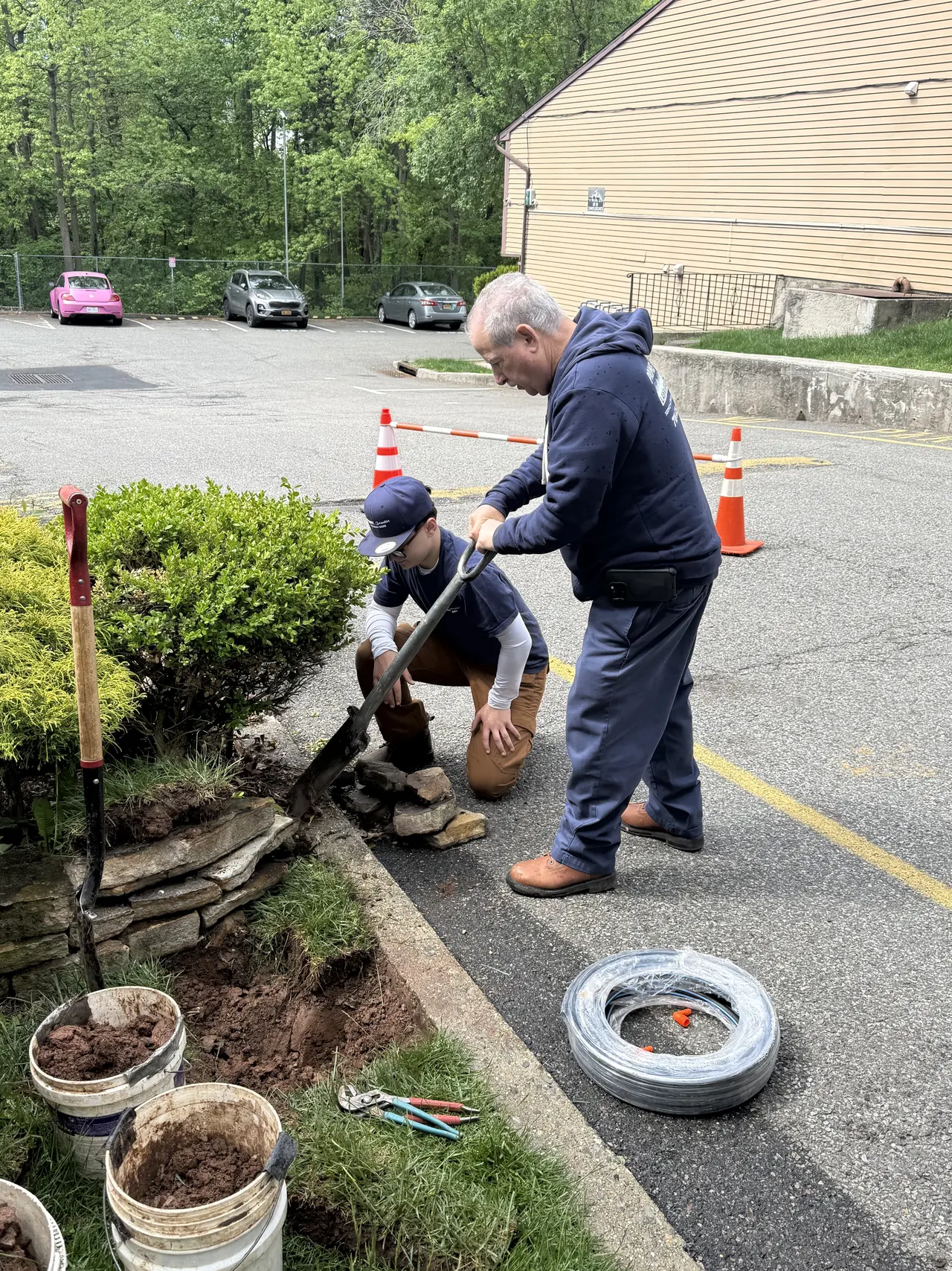 Prime Sprinkler crew opening a curbside trench for irrigation work