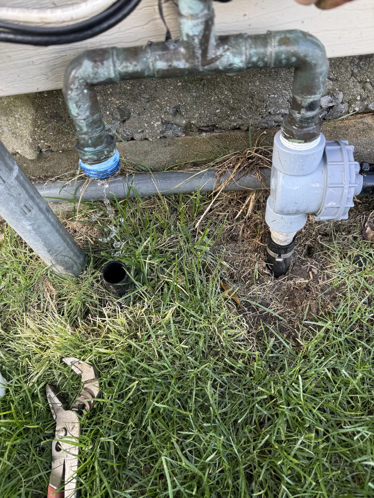 Copper manifold piping close-up during sprinkler service