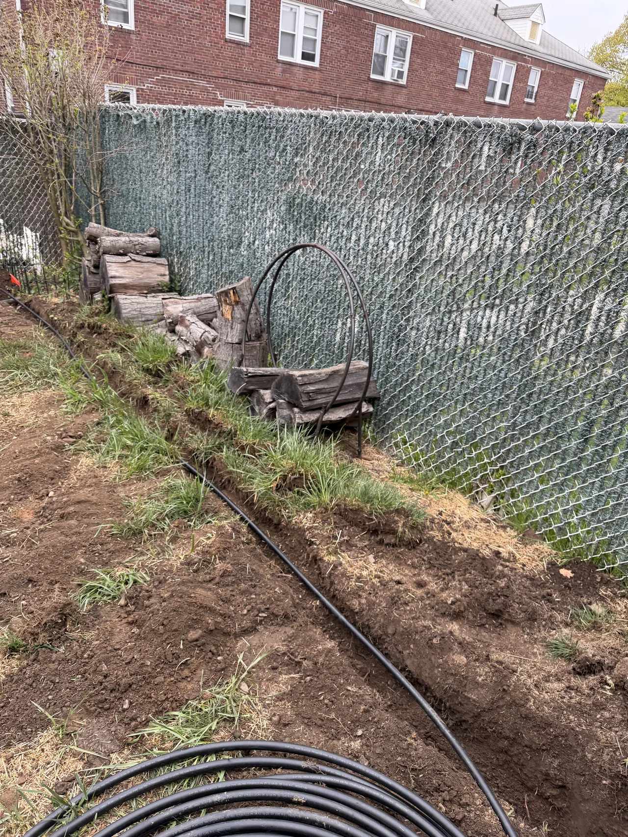 Sprinkler trench line opened along a fence