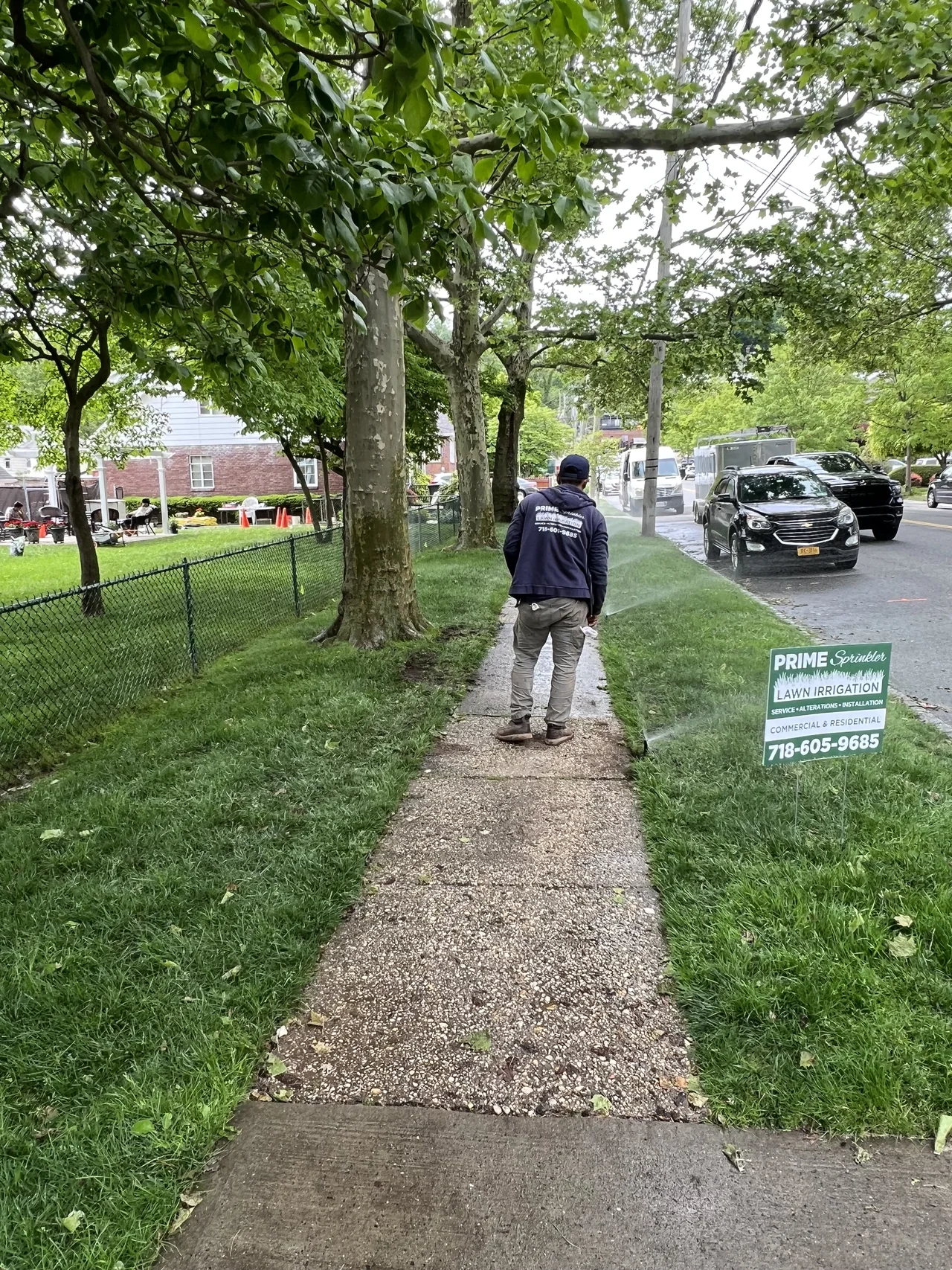 Prime Sprinkler technician working beside a Staten Island walkway