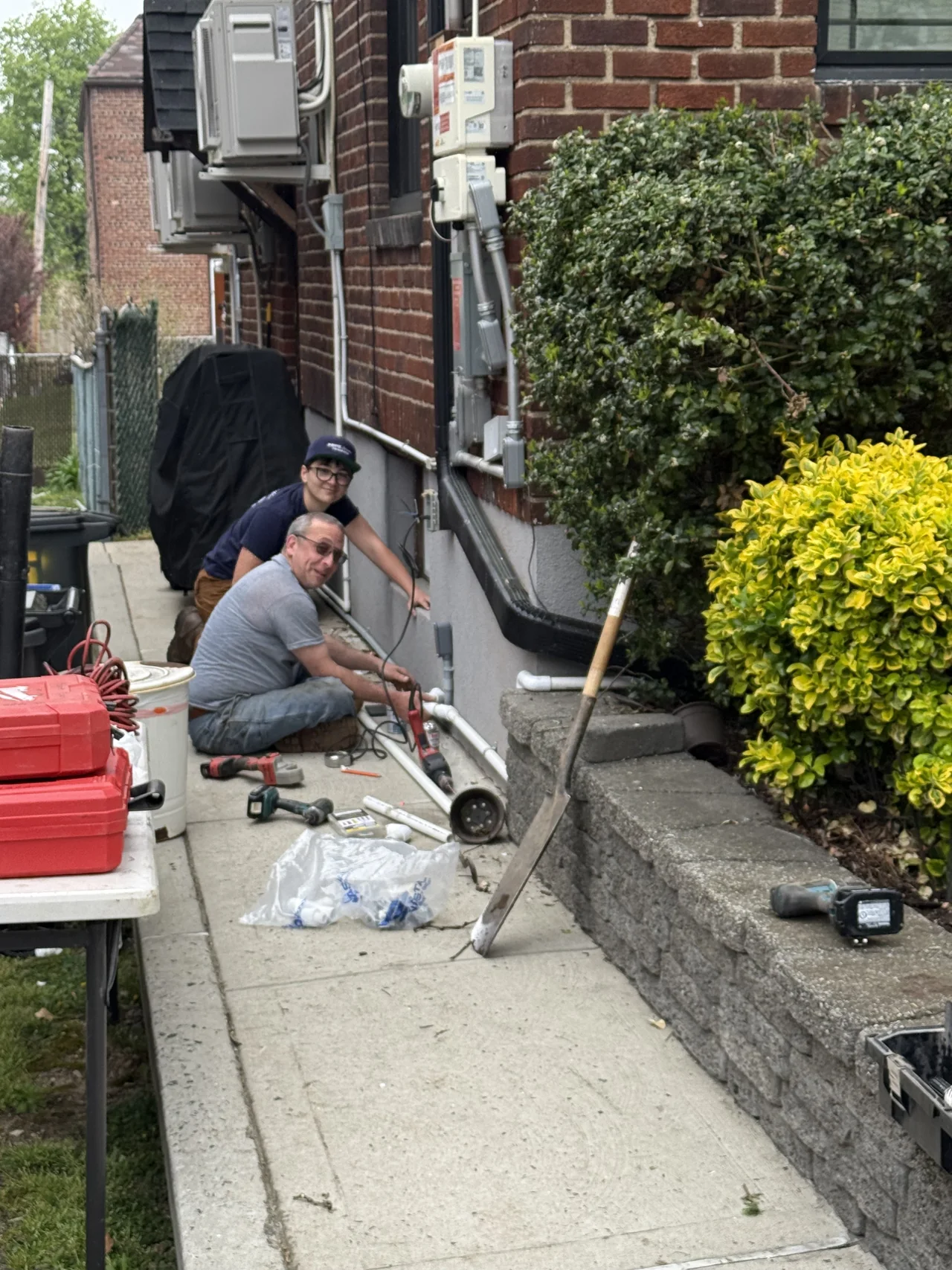 Prime Sprinkler technician working in a side yard